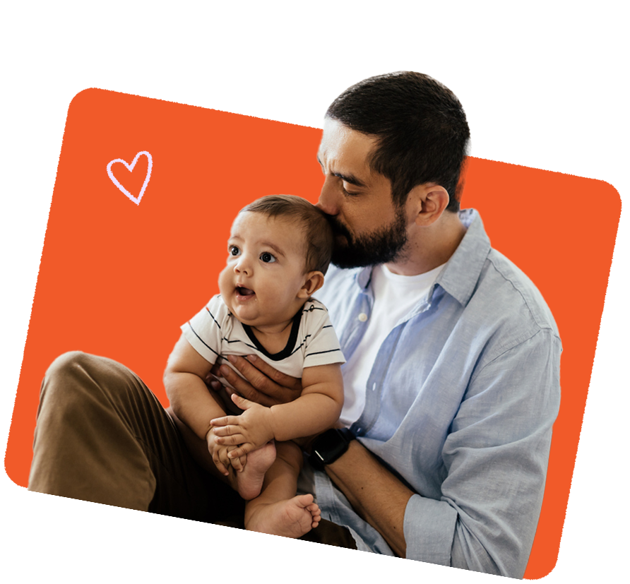 Parent gently kissing a baby's forehead