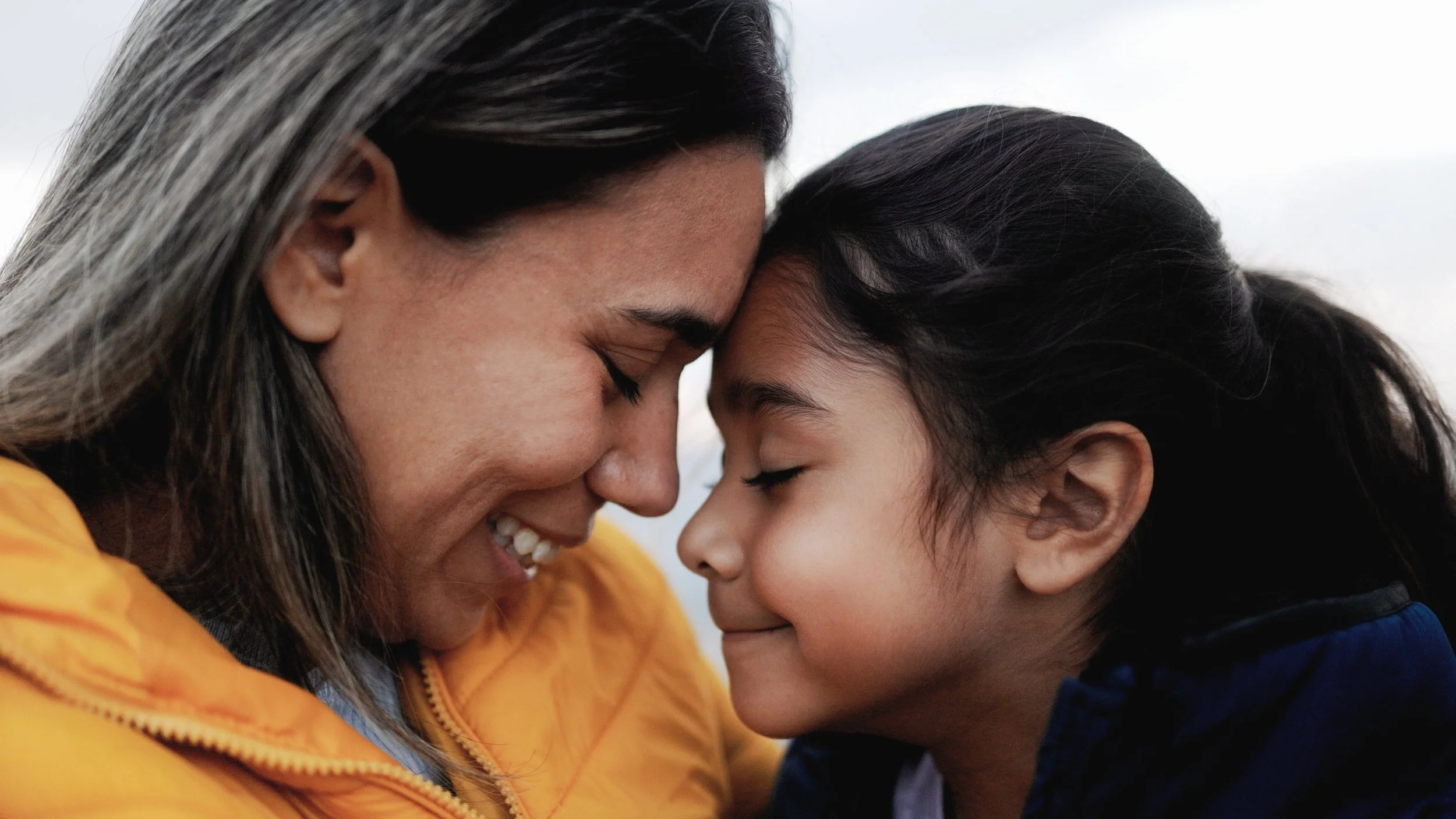 Mother embracing her daughter in a tender, comforting moment
